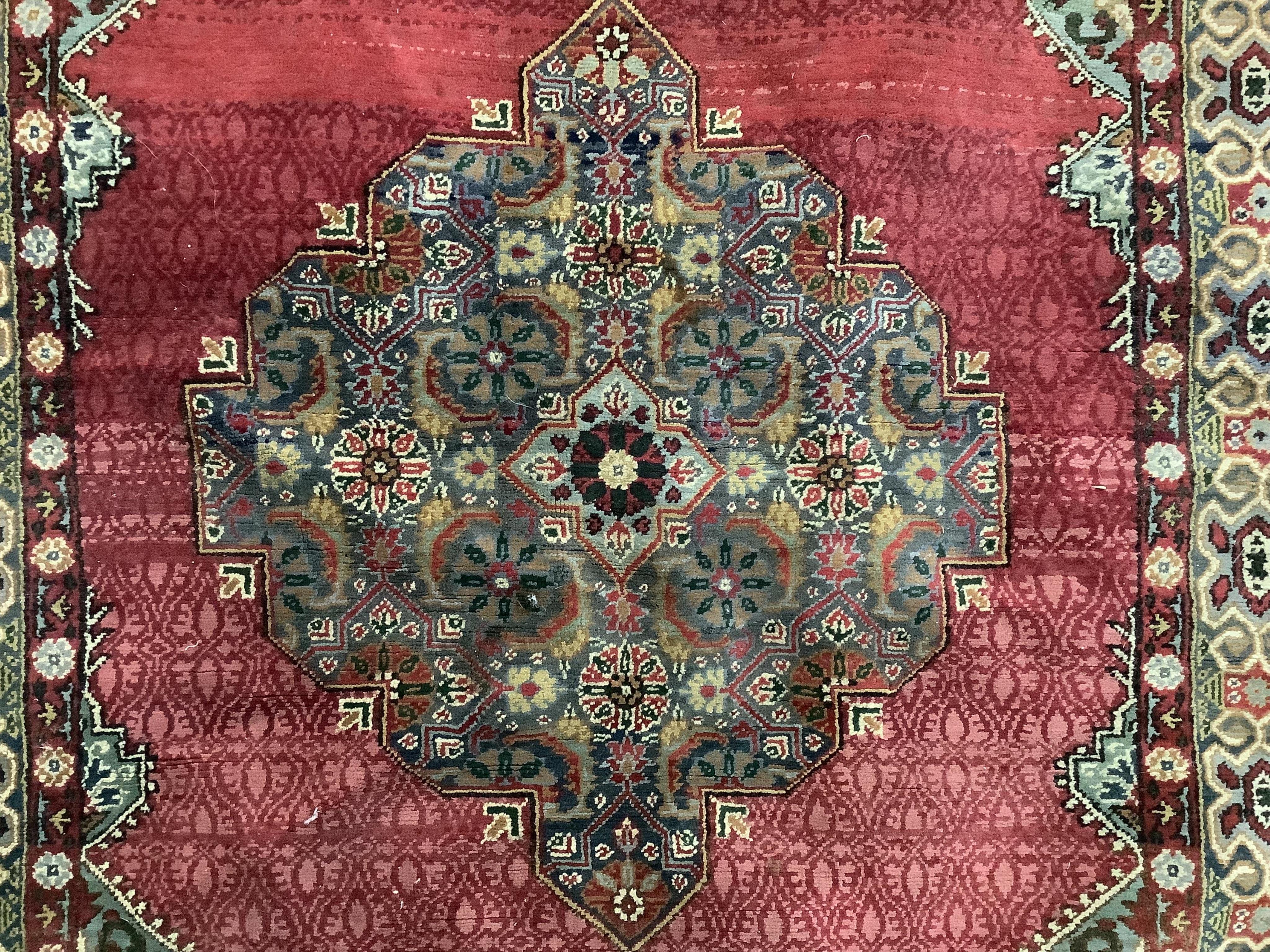 A North West Persian red ground rug, 170 x 106cm. Condition - faded and worn at the fringes